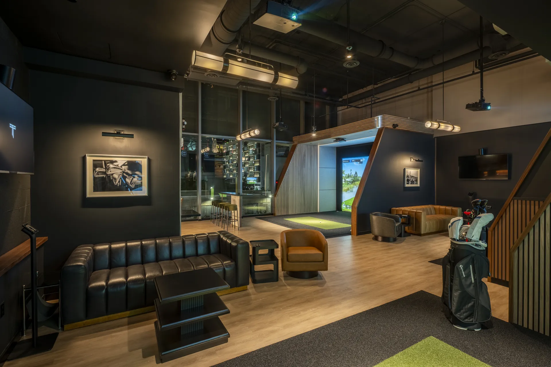 The Tips restaurant bar with dark wood paneling and pendant lighting, South Florida restaurant design by Hybrid Creative